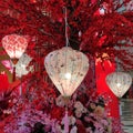 Three peach color chinese new year celebration lantern with artificial flowers tree as background