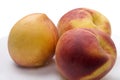 Three peaches on a plate, background on pure white Royalty Free Stock Photo