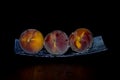 Three peaches on a platter