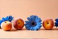 Three peachs and two blue flowers on a table Royalty Free Stock Photo