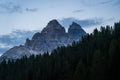 Three peaks in the Dolomites in the Italian Alps at dawn with pine trees in the foreground near lake Misurina Royalty Free Stock Photo