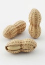 Three peanuts in their shells isolated on white background Royalty Free Stock Photo