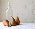 Three pears with glass bottle