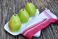 Three Pears on the white plate wooden background Royalty Free Stock Photo