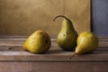 Three pears on wooden table