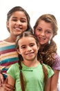 Three peas in a pod. Cropped portrait of three young girls standing indoors together. Royalty Free Stock Photo