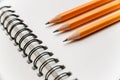 Three pencils lie in parallel on a blank piece of paper. Royalty Free Stock Photo
