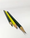 three pencils two green one yellow graphite black wooden colored side by side