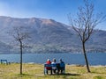 Three pensioned seated on a bench in Lake Como Royalty Free Stock Photo