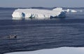 Three People in Boat and Icebergs Royalty Free Stock Photo