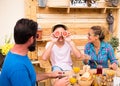 Three people at breakfast with funny faces. Happy family with teenager son. Smiles and love. Wooden table and background