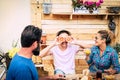 Three people at breakfast with funny faces. Happy family with teenager son. Smiles and love. Wooden table and background