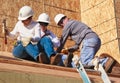 Three people build roof for home for Habitat For Humanity Royalty Free Stock Photo