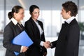 Three people in business attire shake hands Royalty Free Stock Photo