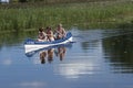 People paddeling a canoe on a river in Lithuania
