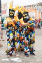 Three people dressed as grimaces from Maragogipe are seen during Carnival in Bahia, Brazil