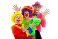 Three people dressed up as colorful funny clowns Royalty Free Stock Photo