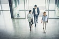 Three people entering the business building. Royalty Free Stock Photo