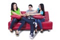 Three people fighting for remote control