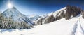 Three people hiking in mountains winter landscape with deep snow on clear sunny day. Allgau, Bavaria, Germany.