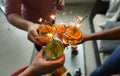 Three people hold glasses and clink glasses. Royalty Free Stock Photo