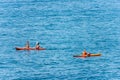 Three People Kayaking in the Blue Sea in Summer - Liguria Italy Royalty Free Stock Photo