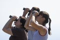 Three people is looking at big binoculars. Birdwatching and spy concept Royalty Free Stock Photo