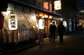 Three people meet in Tokyo at nighttime