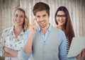 Three people with phone and laptop against blurry wood background Royalty Free Stock Photo