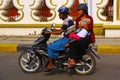 Three people on scooter in Mandalay, Myanmar