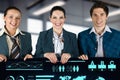 Three people are smiling and holding a large screen with a lot of graphs Royalty Free Stock Photo