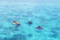 Three people snorkeling in the sea turquoise clear water