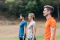 Three people standing doing an outdoor yoga session Royalty Free Stock Photo