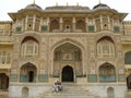 Three people on the steps of the entrance of the Amber fort in Jaipur, India