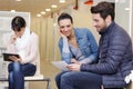 three people in waiting area for medical appointment Royalty Free Stock Photo