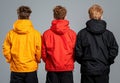Three people wearing different colored hooded jackets. Royalty Free Stock Photo