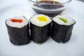 Three Peppers Makizushi Rolls With Soya Sauce Bowl Behind