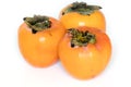 Three persimmons on white background Royalty Free Stock Photo