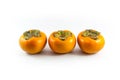 Three persimmons on a white background.