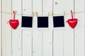 Three photo frame blank and red heart hanging on white wood back Royalty Free Stock Photo