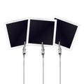 Three photo frames on a metal memo holders clips. Photos, memories card on wire silver clamps over white background. Photo album. Royalty Free Stock Photo