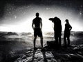 Three  photographers taking pictures of starry sky on high mountain Royalty Free Stock Photo