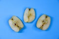 Three pieces of apple on blue background Royalty Free Stock Photo