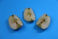 Three pieces of apple on blue background Royalty Free Stock Photo