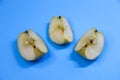 Three pieces of apple on blue background Royalty Free Stock Photo