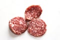 Three pieces of dry-cured sausage