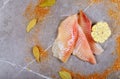 Three pieces of fresh tilapia on marble board