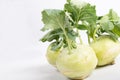 Three pieces of kohlrabi vegetable isolated on yellow simple background with copy space Royalty Free Stock Photo