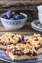 Three pieces of plum cake with crumble