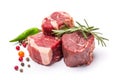 Three pieces of raw meat with herbs and mixed peppers isolated on transparent or white background. Steaks with rosemary